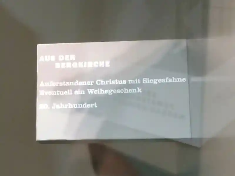 Statue of Jesus with three-point rays on the head holding victory flag